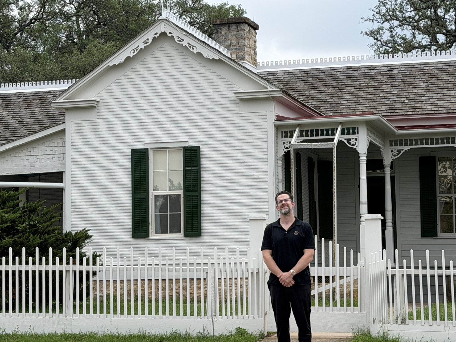 Dr. Kevin Christensen standing in front of Lyndon B. Johnson's boyhood home in Johnson City, Texas.